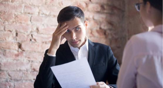 Man looking doubtdully at candidate during a job interview