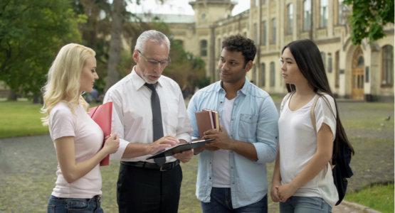 Older man with students outside