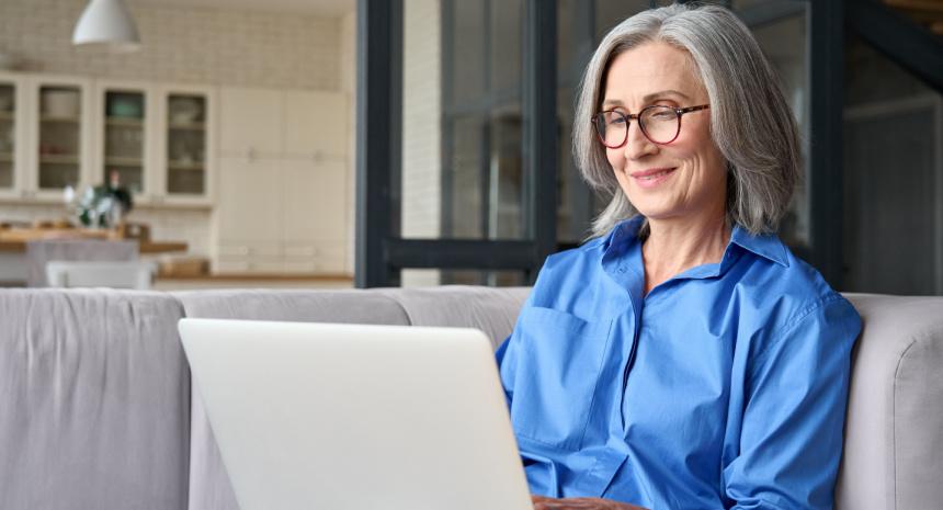 Woman working on a laptop smiling