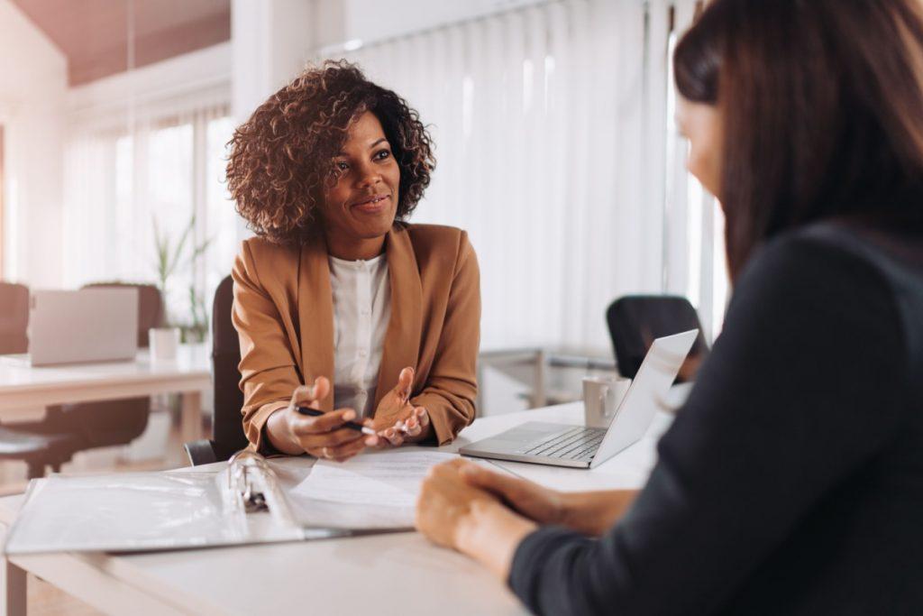 job interviewer looking across table to candidate